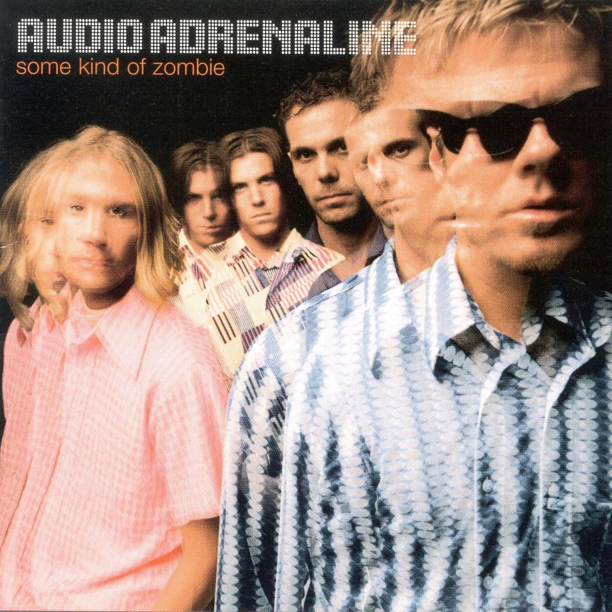 Album Art of Audio Adrenaline's Some Kind Of Zombie album - A photo of four men on a black background. Each person seems to be double-exposed or triple-exposed, as these versions of people overlap and have different poses on top of them. The man on the right has sunglasses, the two men in the middle of the back have dark hair. In the top left, over the photo is printed the band's name in an LED light grid font, and right below it in orange is the album title in orange in lowercase.