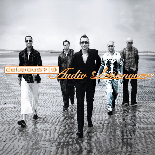 Album Art of Delirious?'s Audio Lessonover? album - A black-and-white photo of five white men walking on a beach, probably at low tide because the ground is pretty wet. Waves can be seen crashing off in the distance, and the sky is grey. Four of the five guys are wearing sunglasses, two are bald and the other three have short hair, though a bit of a mohawk spike down the middle is longer on two of them. The men on the left and in the middle have a smile on their face, while the rest look pretty serious. Printed on top of the photo is the band's word mark, the band name in a box with a 'd:' after it, in white with orange lettering. And to the right of that in a fancy serif-script font is the album title.