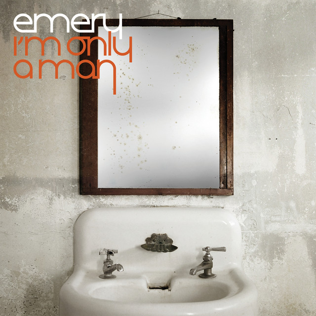 Album Art of Emery's I'm Only A Man album - In what looks like a bathroom with no paint on the walls, just sheetrock, there is an old, white sink with two taps, one on each corner of the sink, and a metal soap holder in the middle. Above it is a mirror with a wood frame which is kinda frosted so you cannot see the reflection. In the top left, the band name is in white and the album's name is below in orangish-red.