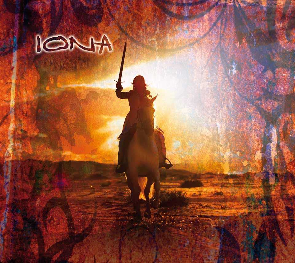 Album Art of Iona's Another Realm album - A photo of a long-haired person silhouetted by the sunlight, riding a horse towards the camera and holding a sword upwards in their right hand. The ground looks pretty arid with hills in the distance on the horizon. Layered on the edges is what may be some ancient stonework or artwork, hard to tell. In the top left it has the Iona word mark, all-capital letters written in a flowing script, with a white glow around the letters.