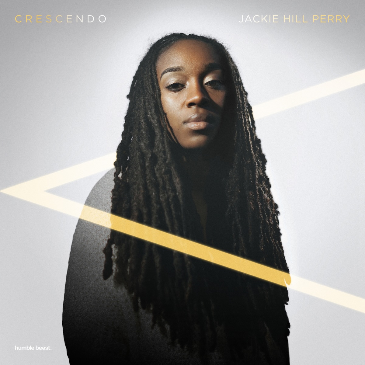 Album Art of Jackie Hill Perry's Crescendo album - On a white background which is a bit more grey at the edges, there's a color photo of a black woman with long, braided hair looking into the camera while holding her chin high. From left to right, there is the musical symbol '<', which is a crescendo. It means the music starts quiet and gets progressively louder. The top part of the '<' passes behind the artist, but the bottom part is in front of her.</body></html>