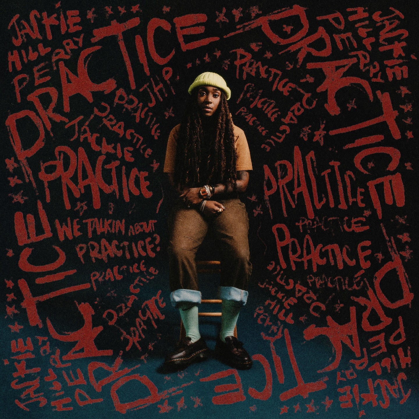 Album Art of Jackie Hill Perry's Practice EP - A black woman with long braided hair and wearing brown jeans and an orange-brown shirt plus a light green beanie is sitting on a wooden stool. Around here are painted the words 'Practice' and her name many times.