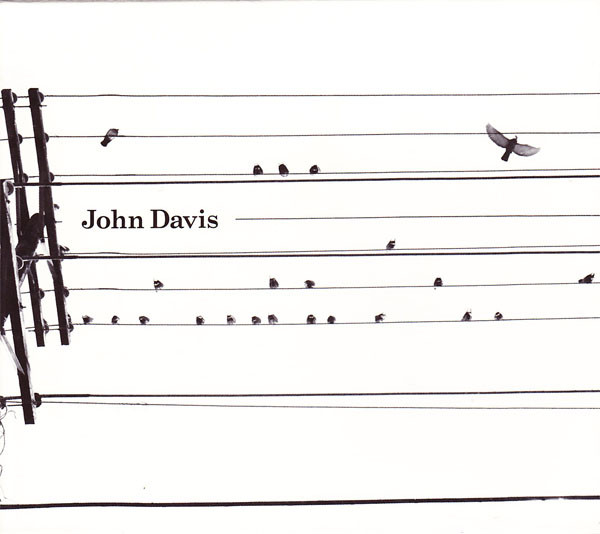 A black and white drawing or photo of looking up at some power lines. On the left, you can see the top of a pole holding up the lines. But across are about 10 power lines, 7 of which are very equally spaced apart. Small birds are sitting approximately equally spaced on the lines, such that they almost look like music notes. The artist's name is printed above the center line on the left side.