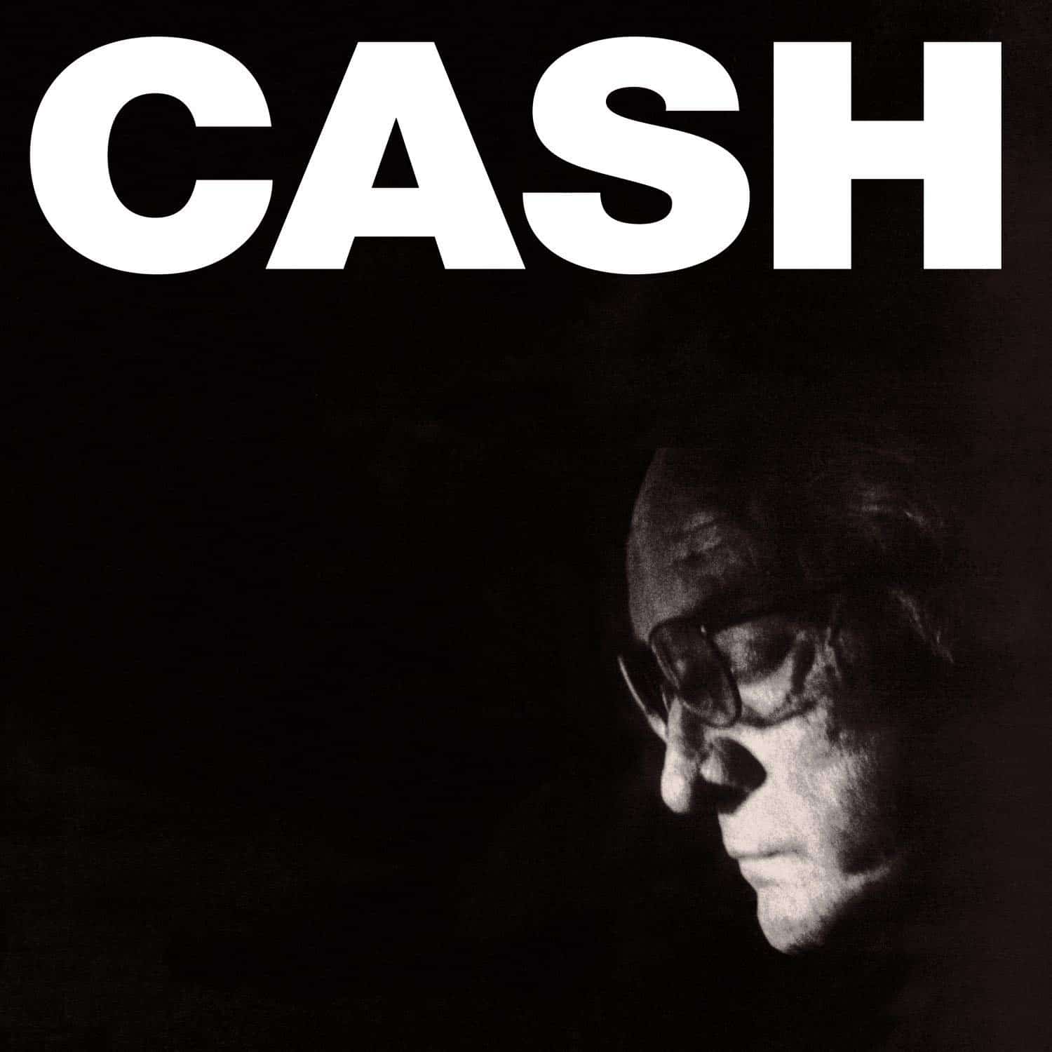  The Man Comes Around album - Out of the black background, a light illuminates the face and forehead of an old white man, Johnny Cash. Above in huge letters is his last name, 'Cash'.