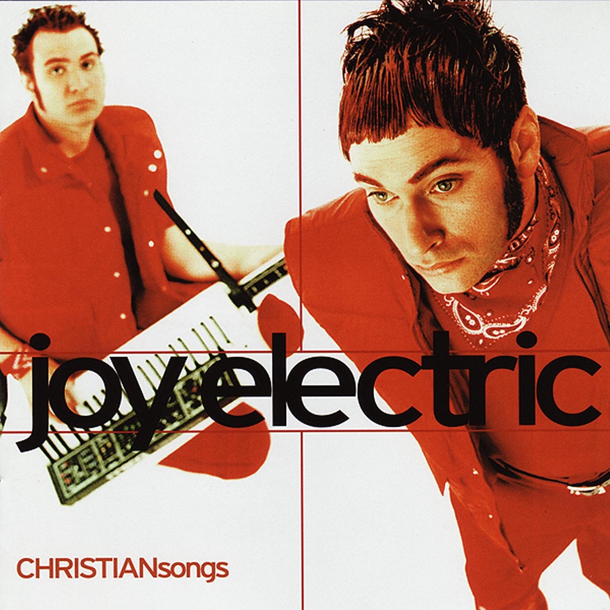 Album Art of Joy Electric's CHRISTIANsongs album - A color photo of two white men in bright red suits on a white background. Both have fairly short, brown hair and sideburns, and the one on the left is holding a keytar. Neither of them are looking at the camera and are looking in different directions. About 2/3 of the way down vertically the band name is printed horizontally across the photo in large black text. In the bottom left corner, printed above the white in much smaller red text is the album title, 'CHRISTIANsongs'.