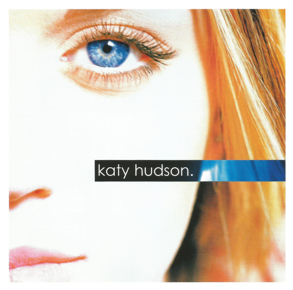 Album Art of Katy Hudson's self-titled album - A close-up photo of the right side of a white girl's face, cut off at the nose and just above the eye and below the mouth. She has blue eyes and pink lips and brown-blonde hair. The picture is pretty blown out so her skin looks mostly white. In the middle, on top of her cheek, there's a box where the colors seem to be inverted and it shows a black background with the brown hair looking blue off to the right. On the black is printed the artist's name in lowercase with a period after it. There's a small white border around the edges.