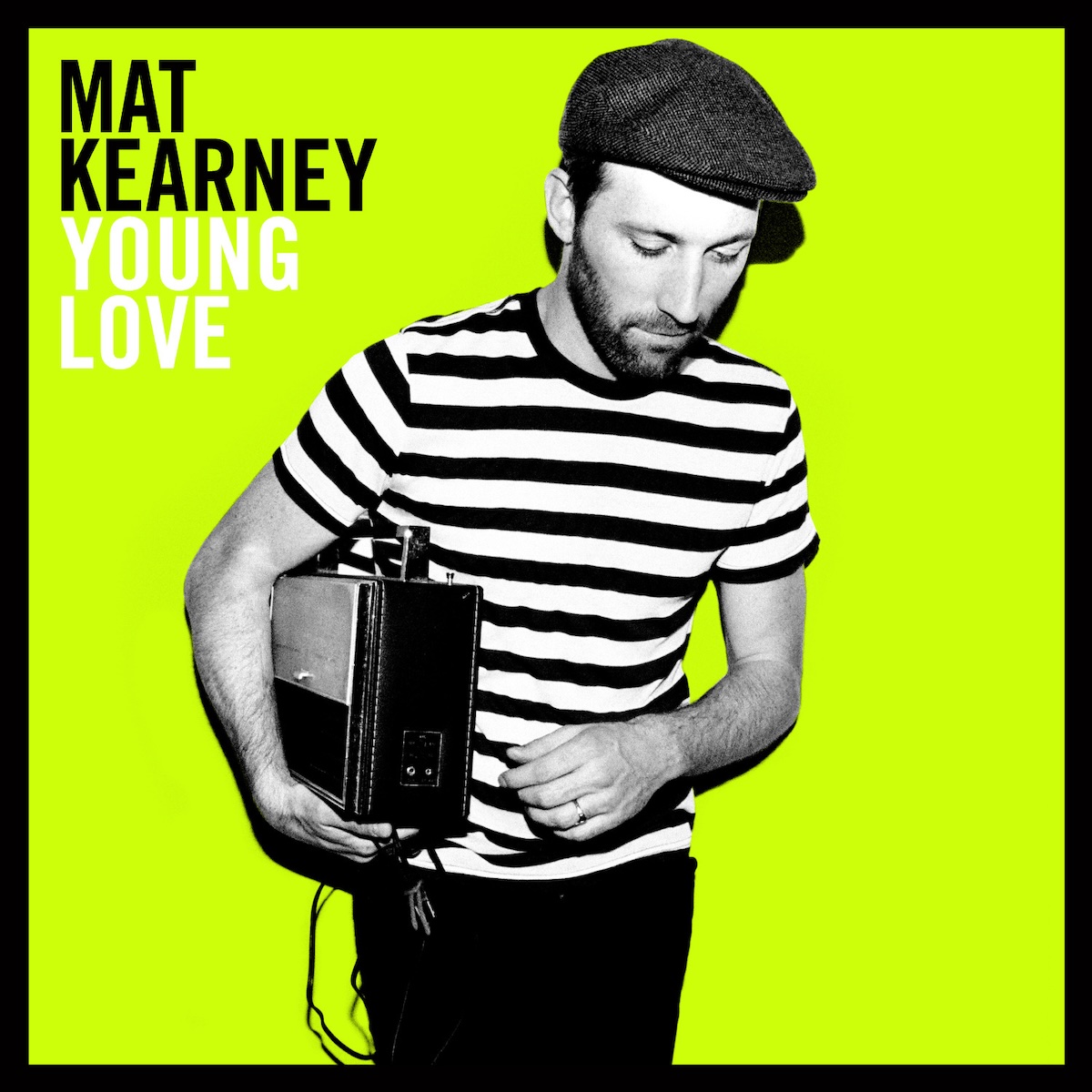 Album Art of Mat Kearney's Young Love album - On a solid, neon green background, a black-and-white photo of a young man in a black-and-white striped shirt, black pants and old-time cap with a short beard. He's looking down towards something in front of him and holding some sort of old boombox or something in his right arm. In the top left, in black is printed the artist's name in large black letters. The album title is printed below it in the same size but in white. There's a thick black border around the edge.