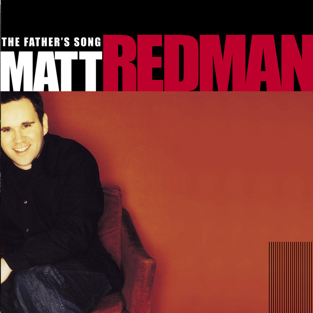 Album Art of Matt Redman's The Father's Song album - The bottom three-quarters is a photo of a reddish-orange wall and a young white man with black hair is wearing blue jeans and sitting in a red chair off to the left, such that most of his left side is out of frame. Printed in the bottom right is vertical black lines above the photo. The top quarter of the cover is a black background with the artist's first name in white in fairly large text, with their last name in red in even larger text to the right. Above the first name in smaller text is the album title in white.