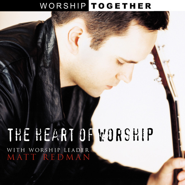 Album Art of Matt Redman's The Heart of Worship album - A close-up photo of Matt Redman leaning forward in prayer, head bowed, holding a guitar by the neck, looking like he's praying before or after a song. The 'Worship Together' label is across the top, and it says 'The Heart of Worship' and 'with worship leader Matt Redman' towards the bottom left.