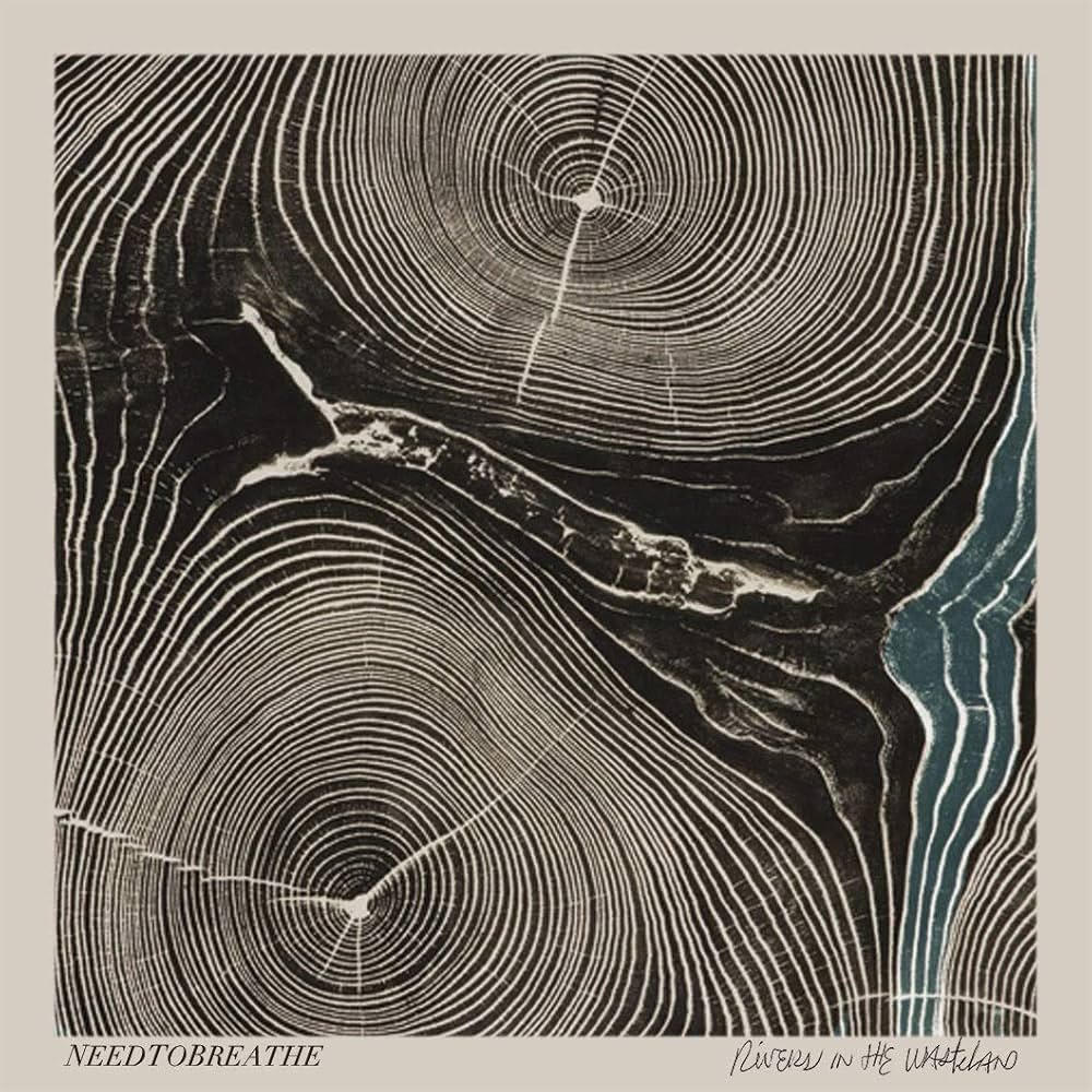 Album Art of Needtobreathe's Rivers In The Wasteland album - On a brownish-gray background is printed what looks to be a cross-section of a piece of wood, with rings surrounding two points like to trees grown together. Most of the space between the rings are black, but a few on the right side are colored blue, like a river. The band's name is printed in small lettering in the bottom left and the album title is scribbled in the bottom right.