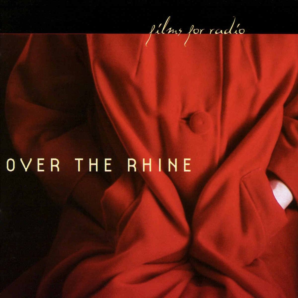 Album Art of Over The Rhine's Films For Radio album - A color photo of a woman wearing a bright red coat with her hands in the pockets takes up most of the space. It looks like she is sitting and her hands are stuffed in the pockets, though we cannot see her shoulders, head or legs. It's mostly just a lot of folds of the coat in light and shadow, with a bit of white skin on the left arm just outside the pocket.</body></html>