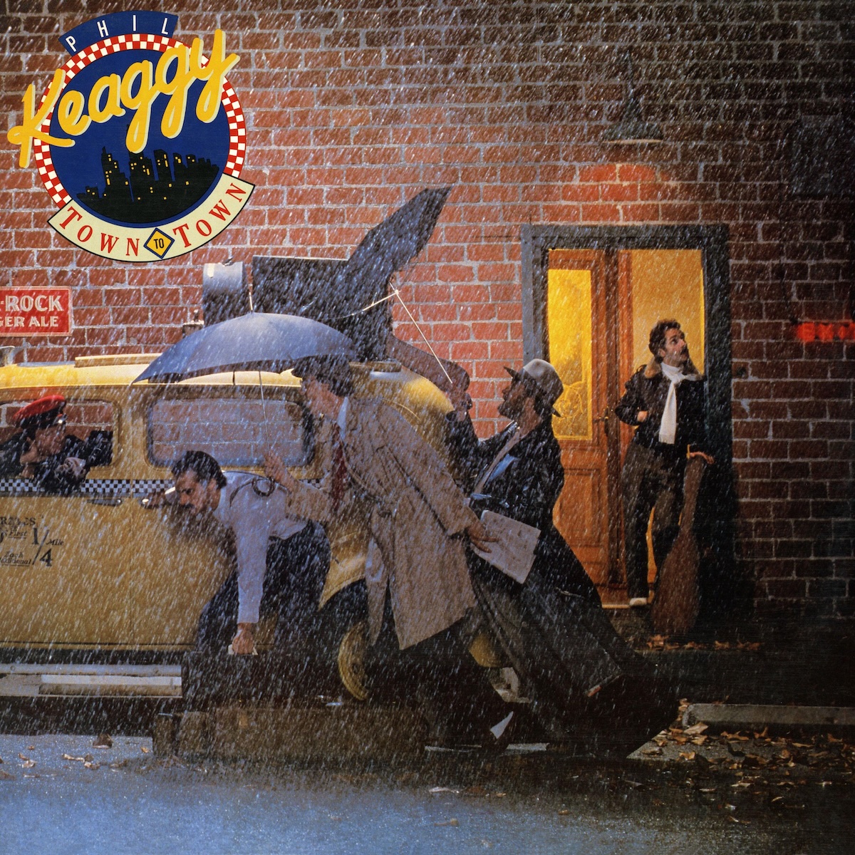 Album Art of Phil Keaggy's Town To Town album - In a downpour on a side street, a man stands in the doorway of a brick building witha. guitar sitting on the steps in front of him as a number of people scramble with luggage and umbrellas working to get inside a yellow taxi cab. The inside of the building is golden and looks inviting, and the man is looking up at the sky and wearing a leather jacket and a sweater, plus is not minding the other people out the door. The scene looks maybe a bit old-timey for the era of this album's release. In the top left, there's a circular design that looks maybe a bit mid-century modern, an illustration of a cityscape of tall buildings at night with a red and white checkered pattern around it, and on the top it says the artist's name, and below it wrapping around the edge is the album name.