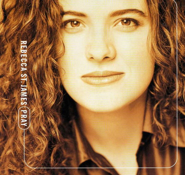 Album Art of Rebecca St. James's Pray album - A close up, sepia-tone photo of a young, white woman with curly brown hair. She only has a hit of a smile on her face. On the left side on top of the photo is printed the artist name and album title in small white uppercase lettering.