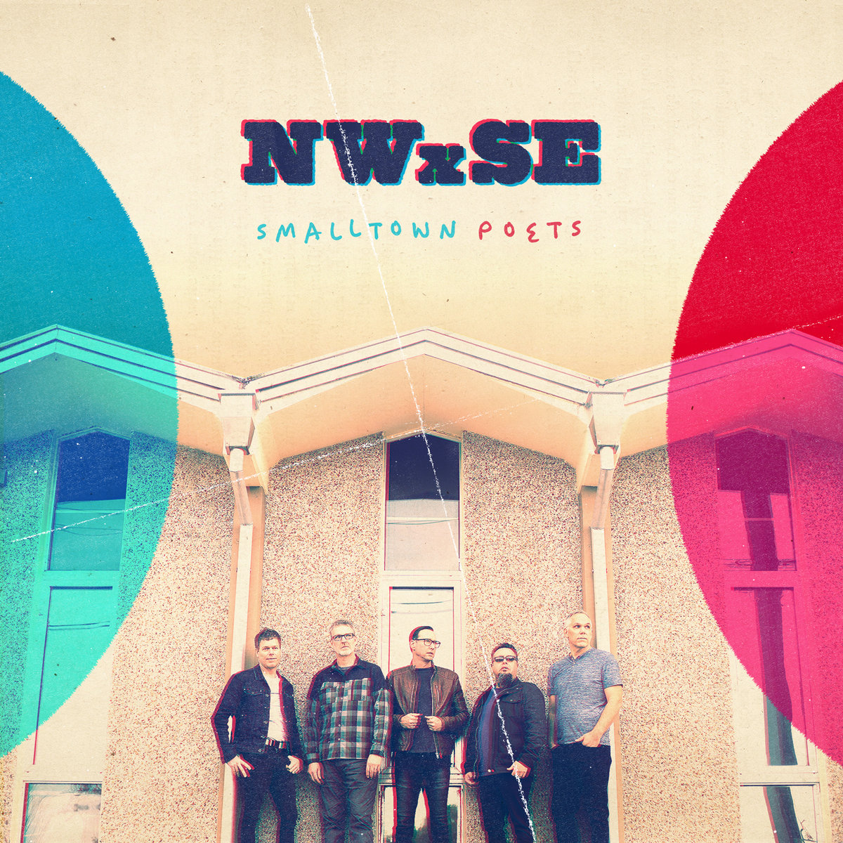 Album Art of Smalltown Poets's NWxSE album - A color photo of five middle-aged men standing in front of a building with stone walls and tall, thin windows and a roof that goes up and down often. The sky above the building is a golden grey/white, almost the same color as the building. On the left side, a portion of a large, blue circle is on top of the photo, and on the right a similar red partial circle is over that edge of the photo. At the top, in the sky, is printed the album title in large, dark blue text with red and blue shadows on opposite sides, and below that printed in smaller text is the band's name in blue and red.