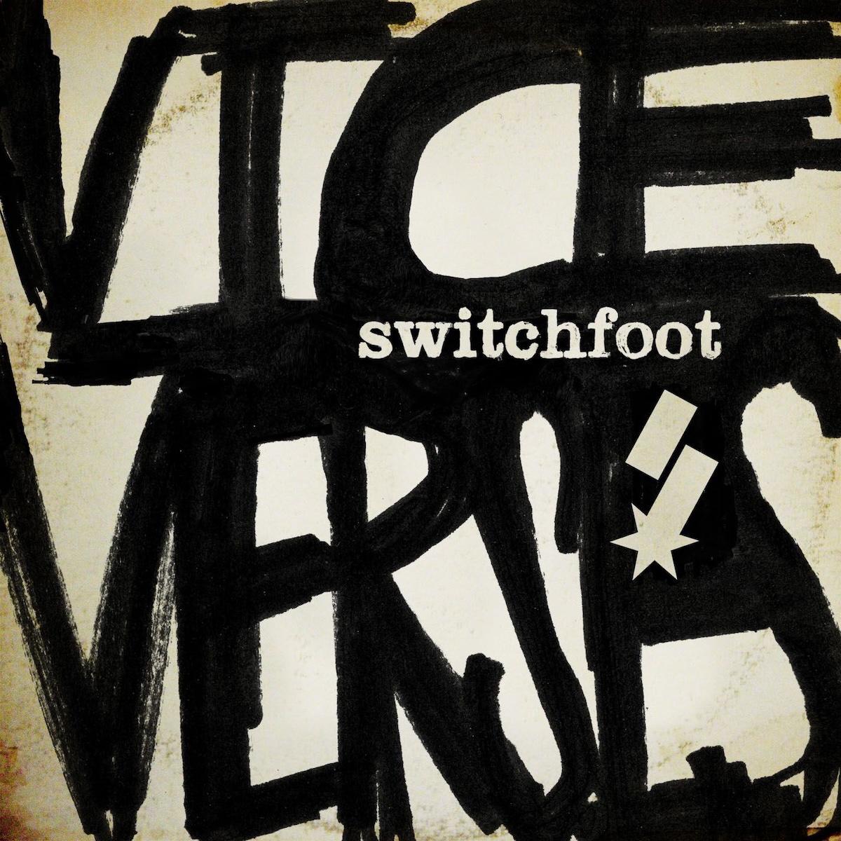 Album Art of Switchfoot's Vice Verses album - On a somewhat golden-hued light background with some ringwear on it, so maybe a worn paper vinyl sleeve, someone took a large sharpie and wrote 'Vice Verses' in all caps, filling up the whole space with huge letters. Where the bottom of the first word meets the top of the 2nd word, that middle area is all black and then cut out of that black is the band name in a a bold, serif font. And below that is a stylized 'S', a word-mark for the band made of two angled blocks, the lower one with a star shape attached to the bottom.
