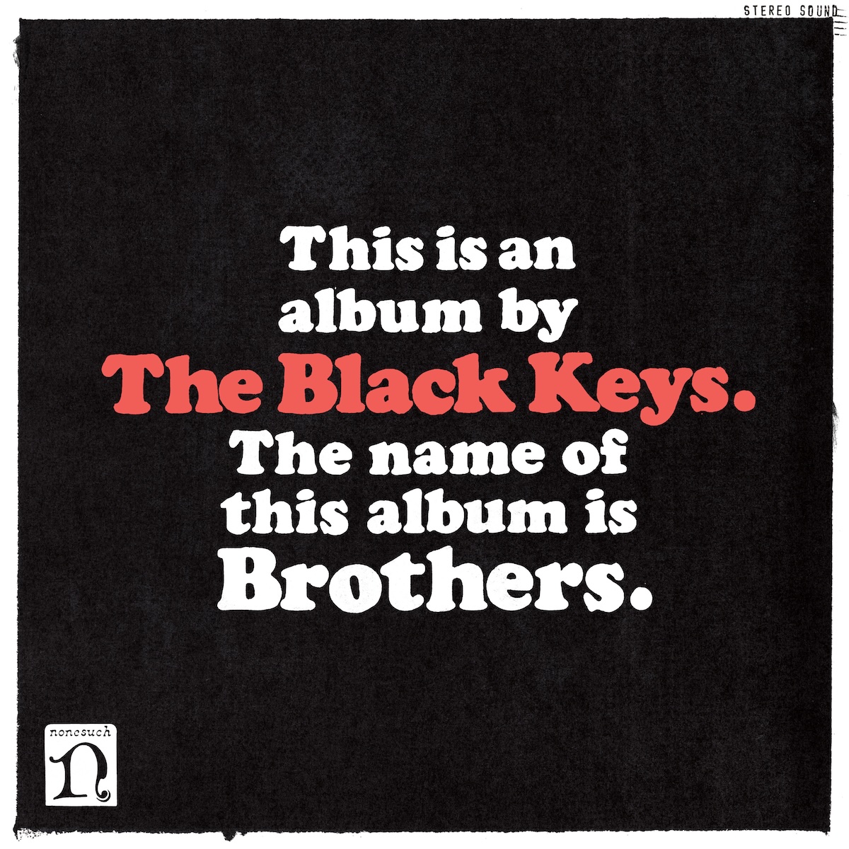 Album Art of The Black Keys's Brothers album - With a rough-edged white border, there is a black background with text written on it. In white in the middle, it says, 'This is an album by' then the band's name in a bigger red print. Then it says, 'The name of the album is' and then the album title, 'Brothers', in a bigger white print. In the border on the edge in the top right corner, it says 'Stereo Sound'. And in the bottom corner, it has the 'Nonesuch Records' large 'n' logo in black inside a white rounded rectangle.