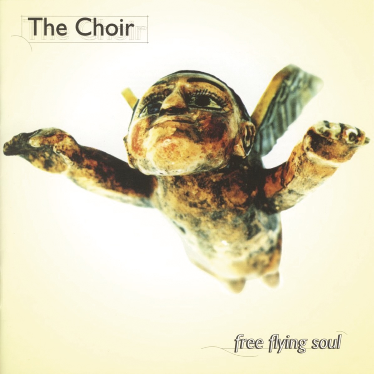 Album Art of The Choir's Free Flying Soul album - On a golden yellow background on the edges which fades to white in the center, what looks like some sort of stone or wood carving of a winged man flying towards the camera from above. His hands are stretched out above the camera and he's looking ahead, above the camera. He's got a big chin and large eyes that seem to be painted on.</body></html>