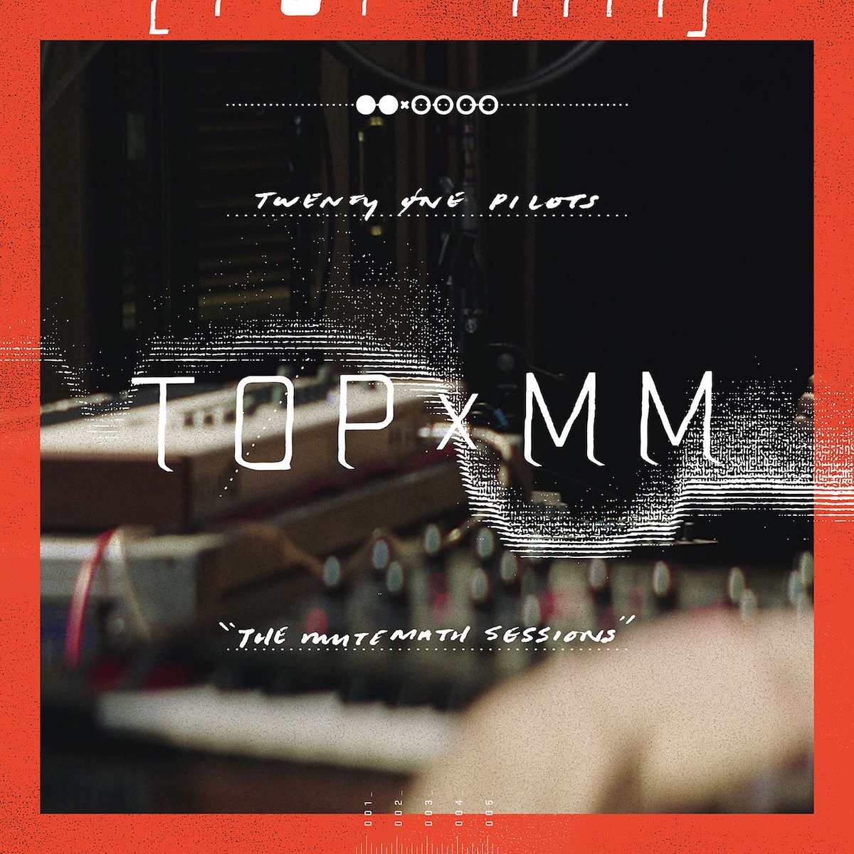 Album Art of Twenty One Pilots and Mutemath's TOPxMM EP - The background is a dark, blurry photo of a few mixers, keyboards, and other electronic gear in a dark room. Around the edges is a red border. Above the image is printed what looks to be some sort of sound wave, and in the middle 'TOPxMM' in white. Towards the top there's a line two white dots, an 'x', then four black dots with a white outline. It then says in printed handwriting-style font the band name with 'The Mutemath Sessions'.
