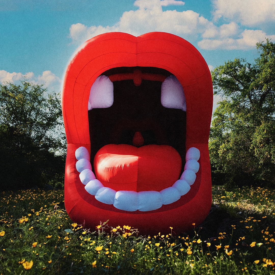 Album Art of Two Car Garage's Peace and Love album - A photo of a field full of yellow flowers surrounded by trees on a sunny, partly cloudy day. In the middle of the photo is an inflated mouth with lips wide open, all the teeth showing except for two missing top front teeth, and a tongue sticking out slightly above the bottom teeth. Inside the mouth is black.