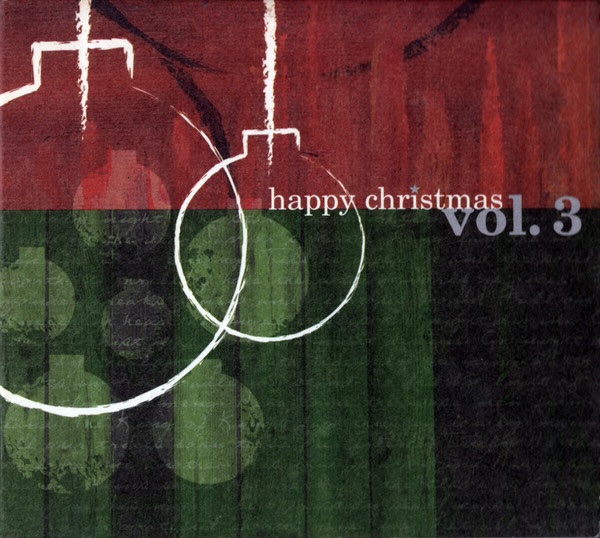 Album Art of the Happy Christmas Vol. 3 album - The top third is a red color, and the bottom two third is a green color. Both have some paint brush lines making a variation in color, and the green part has some handwritten text faintly through it. Above it all is the painted outline of two ornaments in white on the left. In the place where the red and green meet on the write it has 'happy christmas' in white and 'vol. 3' in a larger, grey font to the right.
